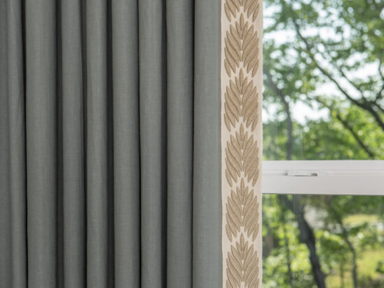 Linen drapery with earth tone trim on leading edge