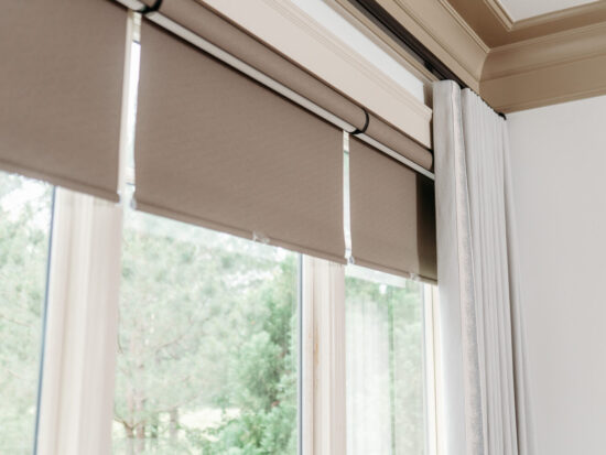 Cordless blackout roller shades over triple window